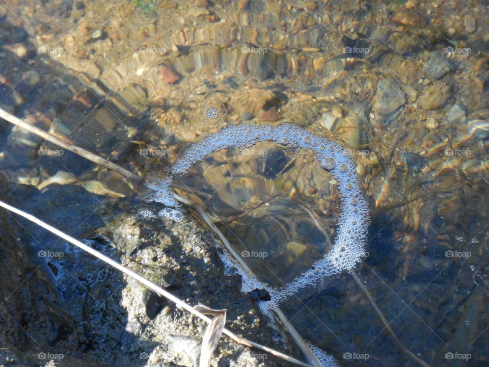 bubble circle by rocky edge of creek