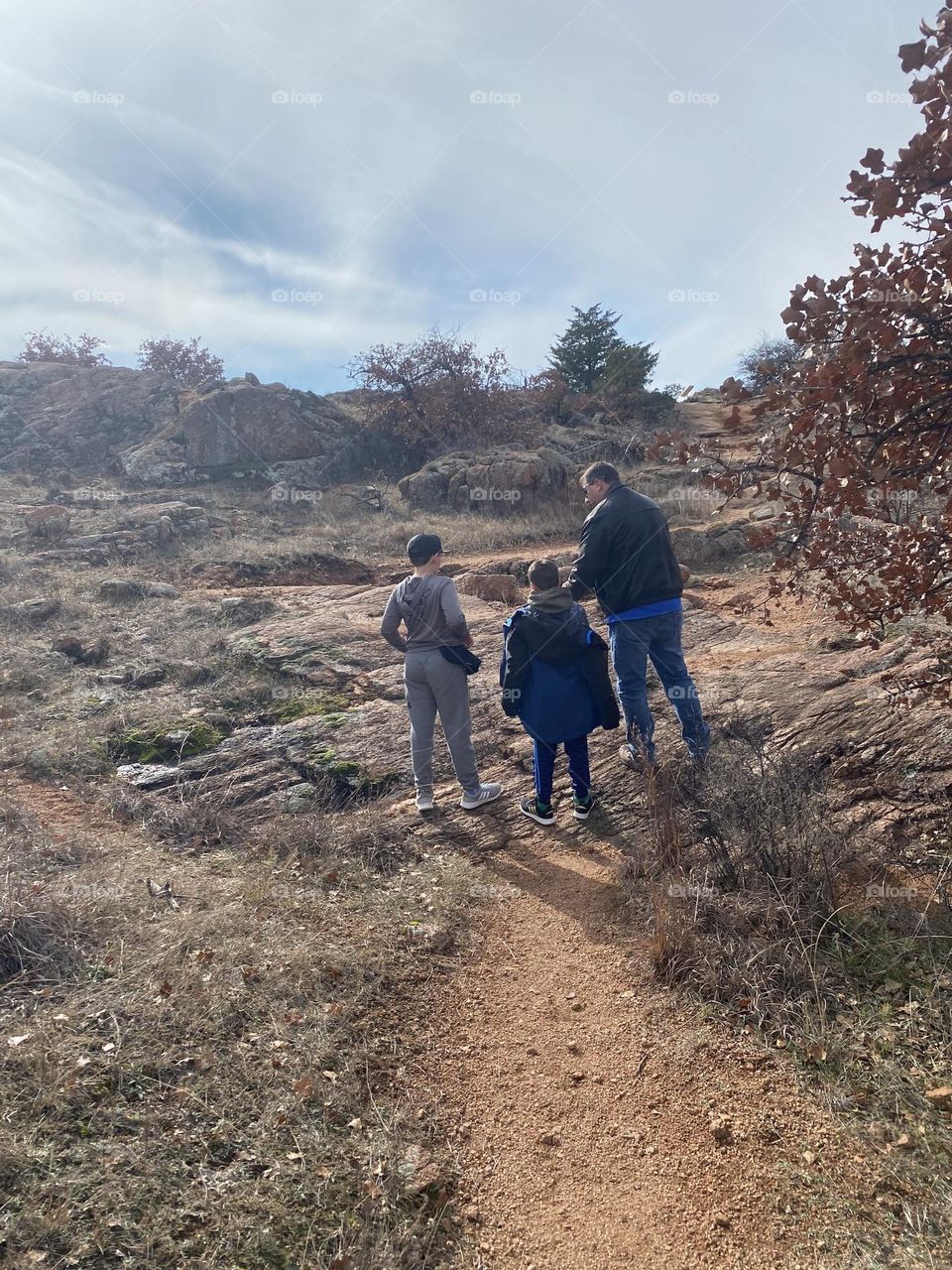 Dad leading his sons on a trail hike in the Wichita Wildlife Refuge in Ft. Sill, OK. 