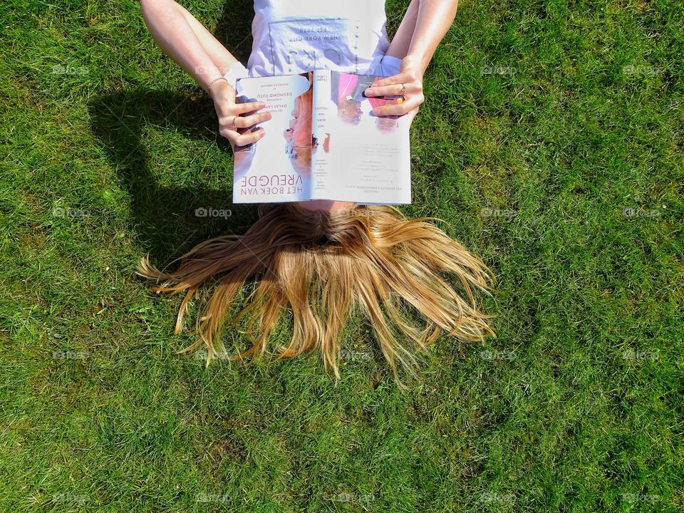 Reading a book in the grass