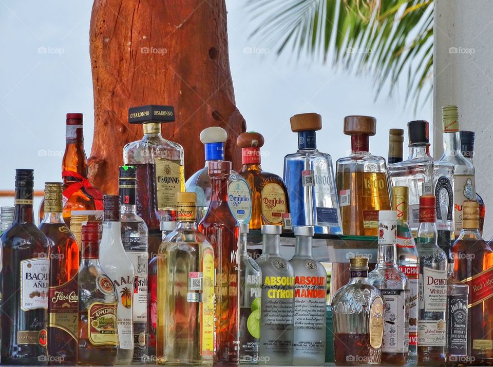 Bottles Of Liquor. Top Shelf Liquor At A Tropical Beachside Bar
