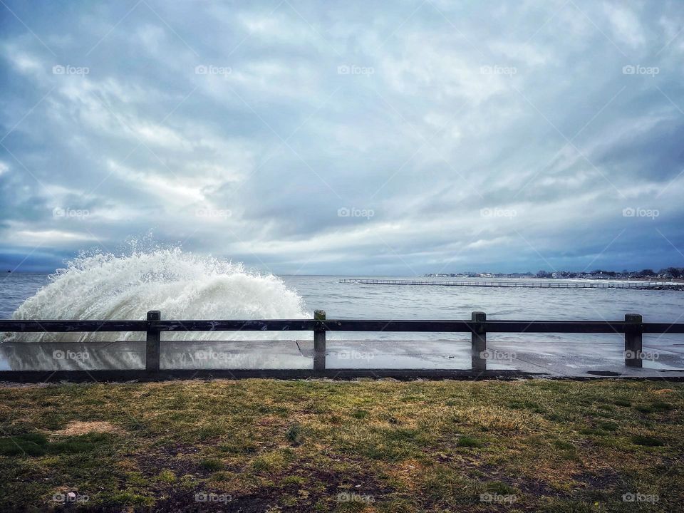 Crashing wave against the seawall 