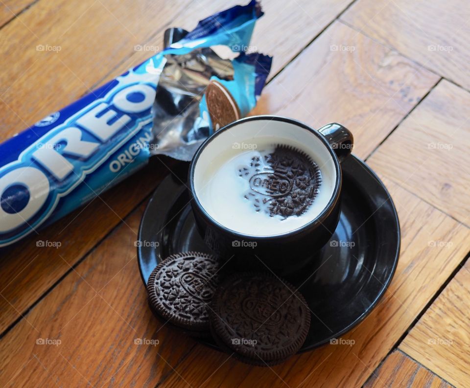 Oreo cookies with cup of milk.