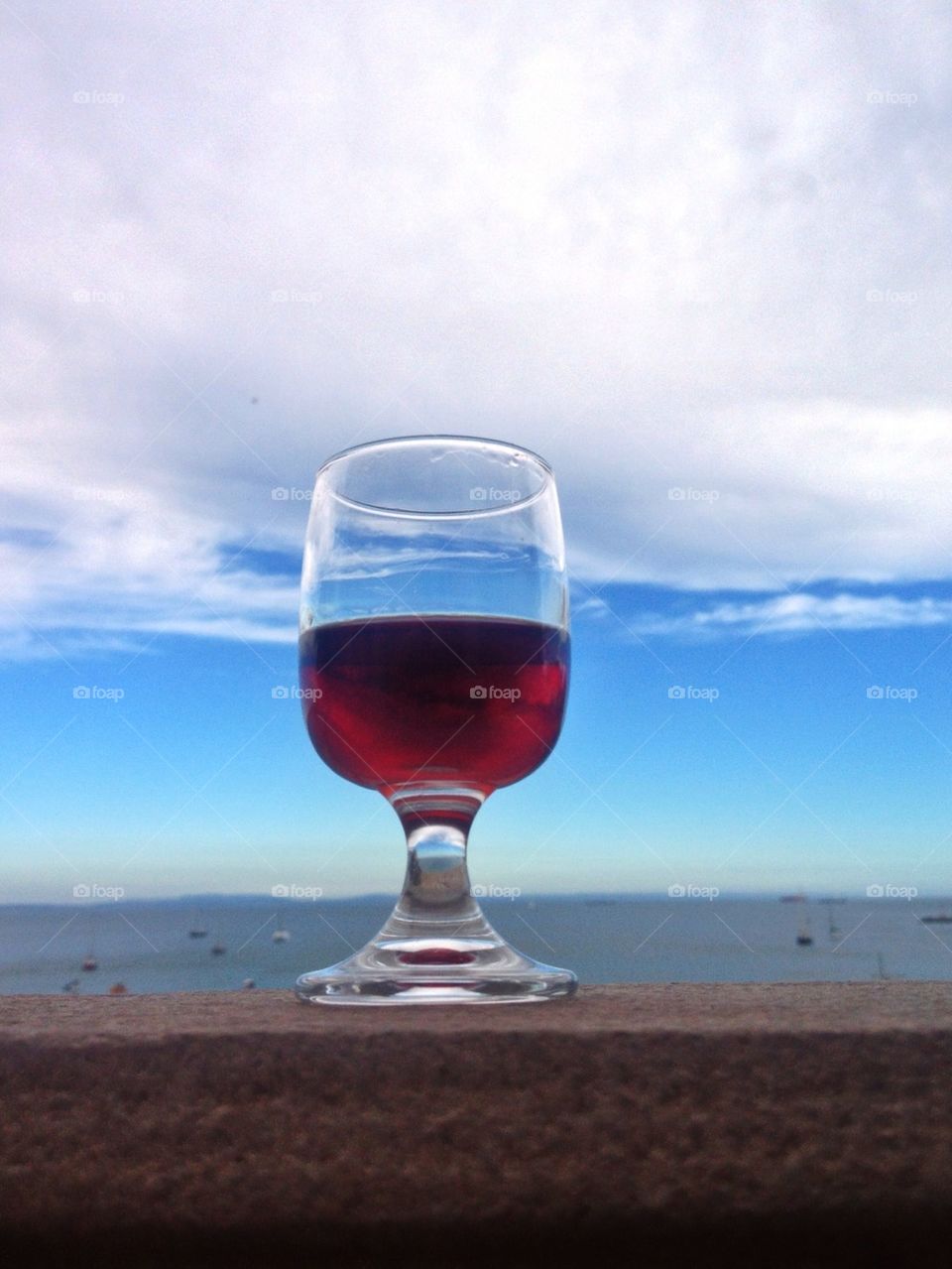 A glass of port wine overlooking the Atlantic Ocean in Portugal