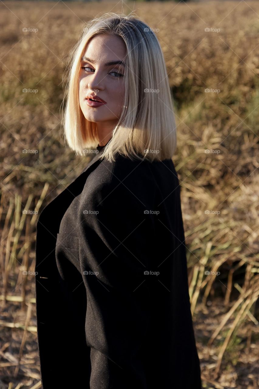 A girl posing in a field