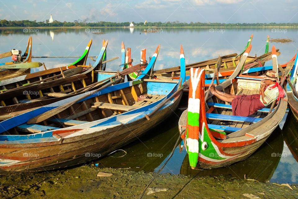 Colorful boats and a boatman