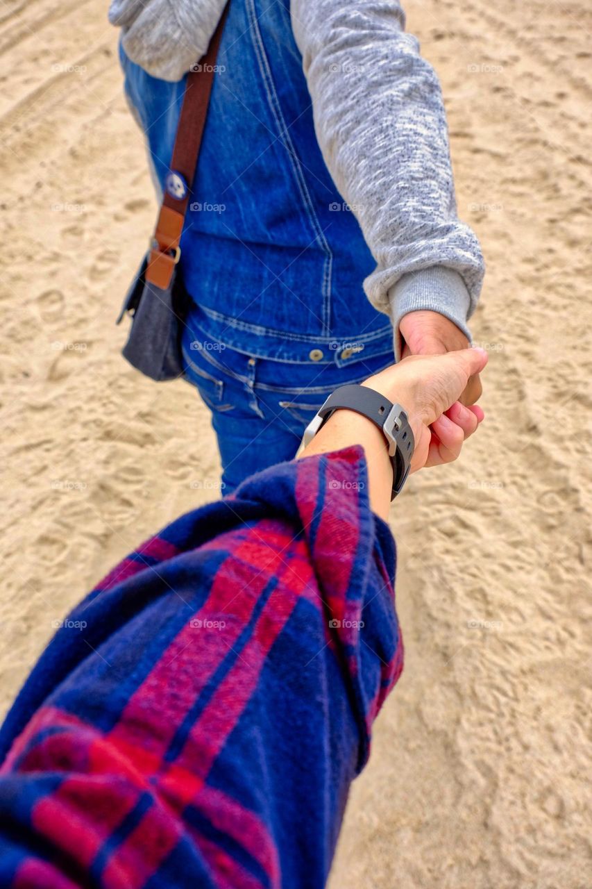 Couple holds hands on beach, homosexual couple in love, lesbians in love, women holding hands, leading lady, take we with you, I will follow wherever you go