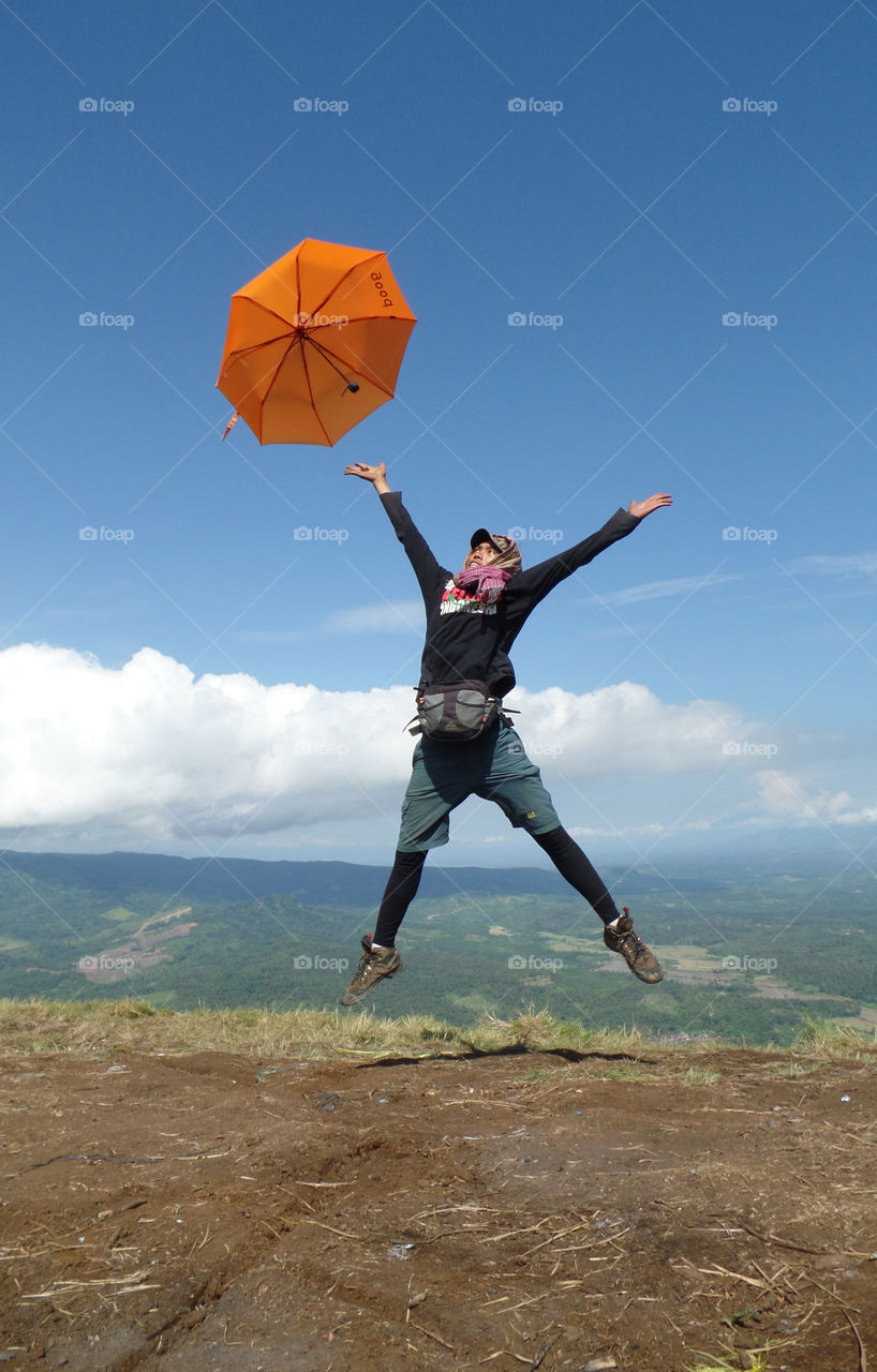Happy Guy with His Umbrella on Bukit Besak Hill Peak at Lahat South Sumatera Indonesia