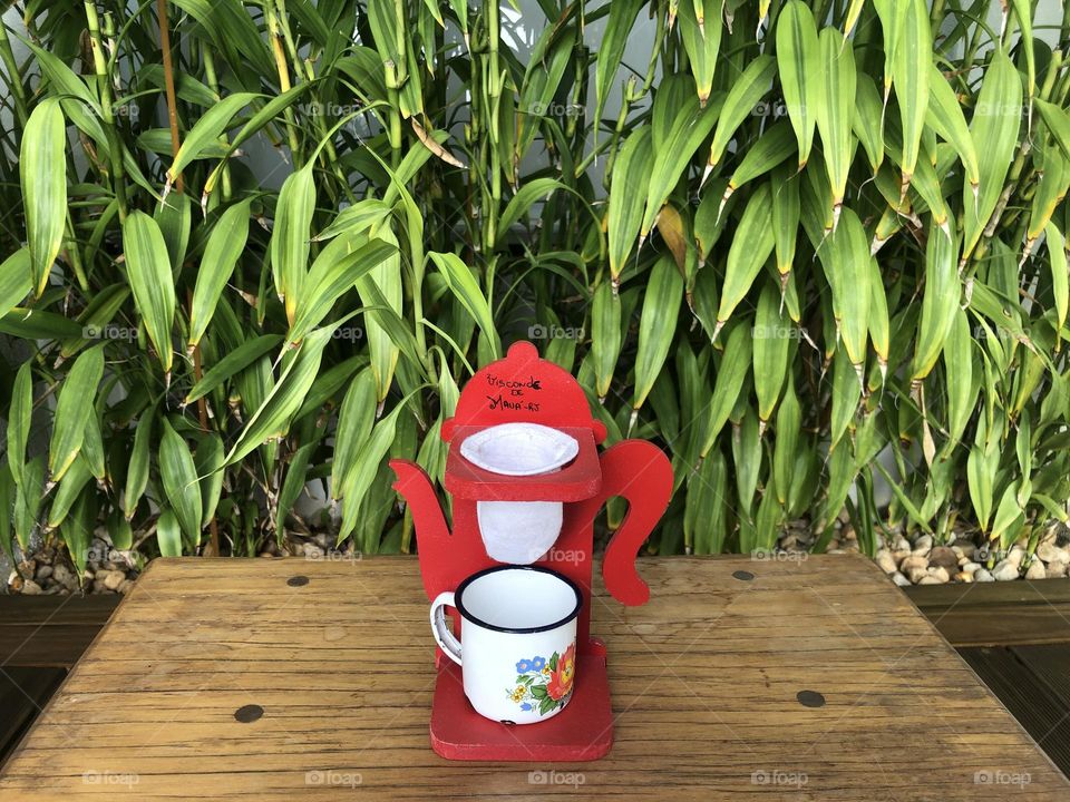 Tissue coffee filter and a sustainable mug in a green surrounding environment