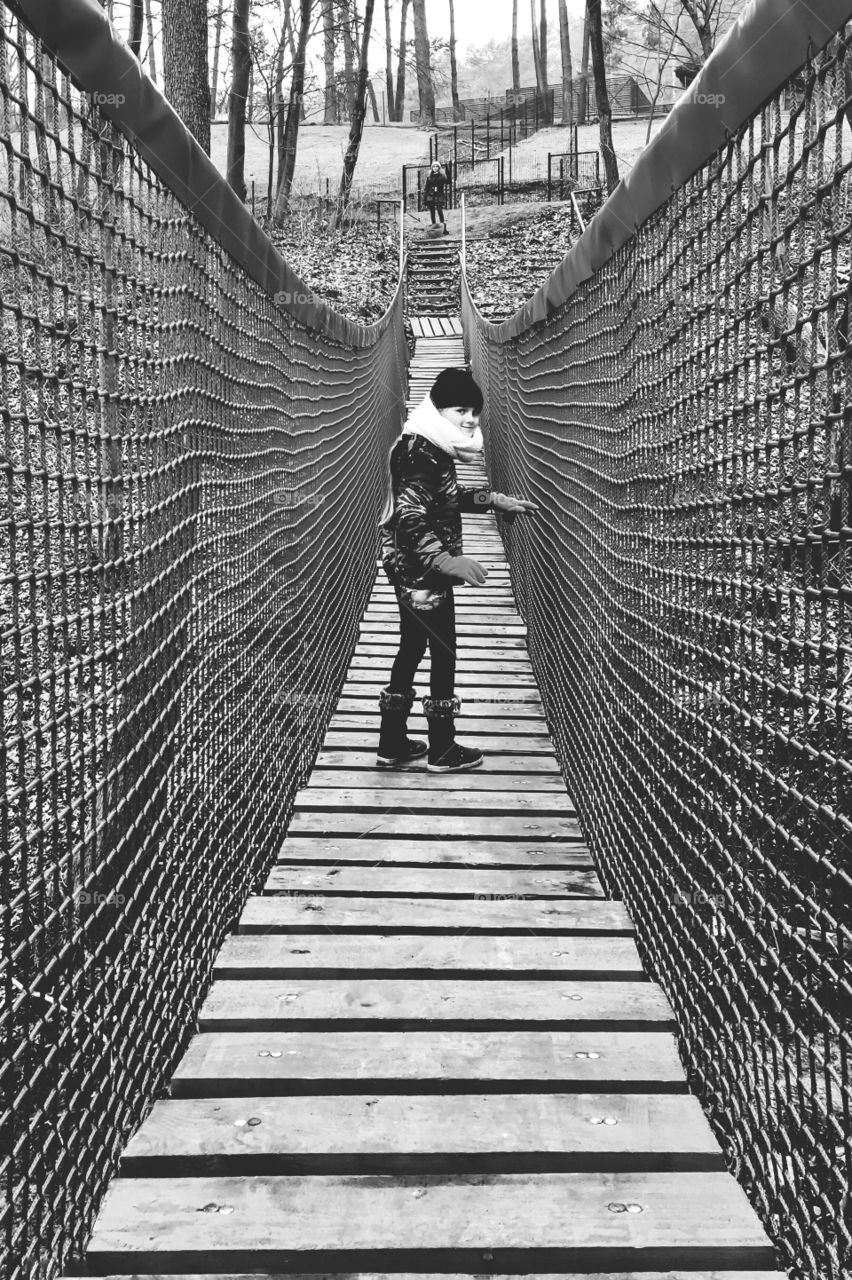 Girl standing on footbridge