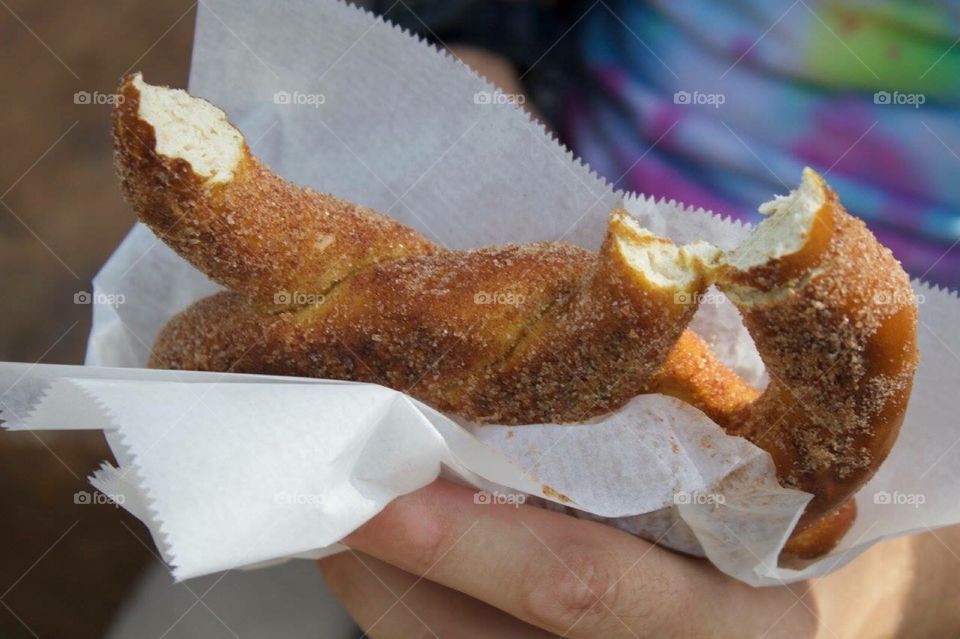 Yummy. A hand holding a pretzel