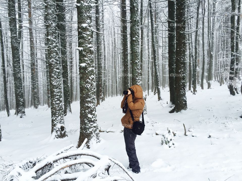 Hiker in snowy forest
