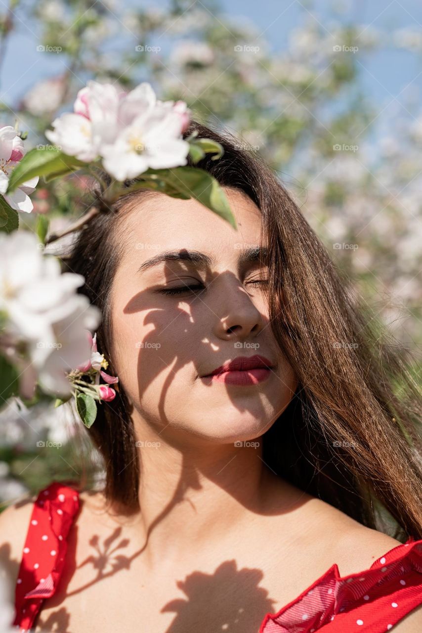 woman in blooming trees with shadow overlay