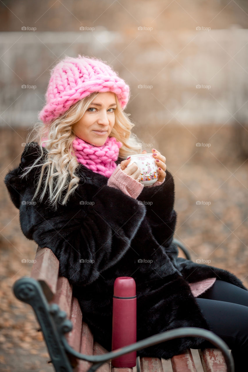 Outdoor Portrait of blonde woman in pink crochet accessories 