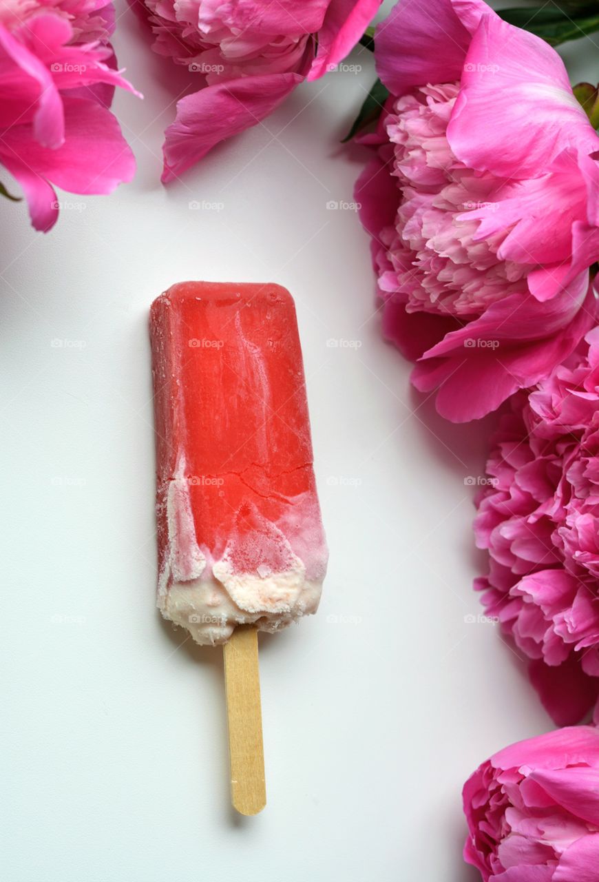 ice cream and peony flowers top view table background