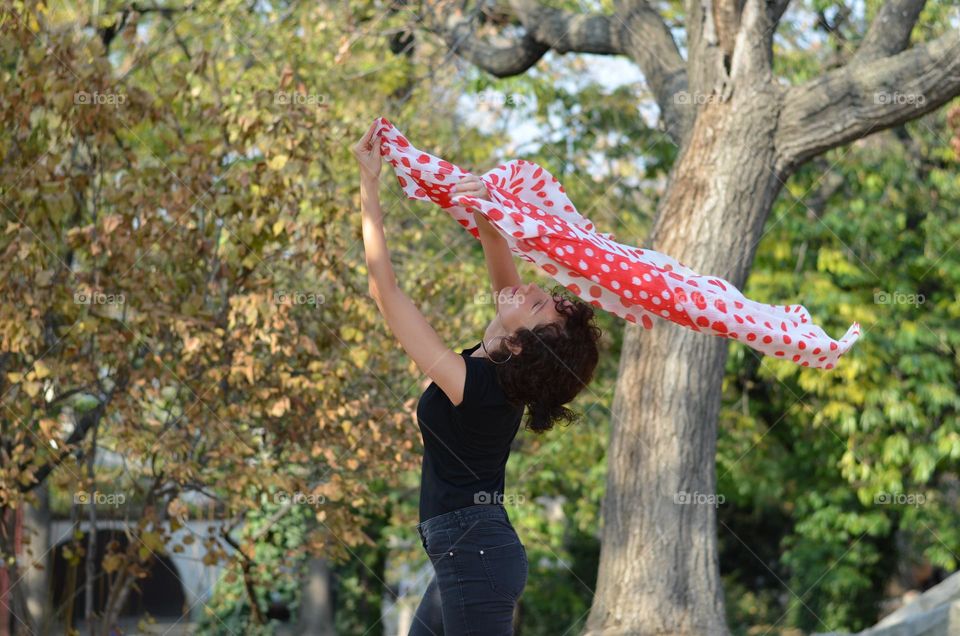 Beautiful Young Woman Dancing with Scarf Outside in Nature