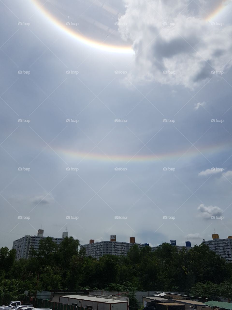 double rainbow sunlight above the city