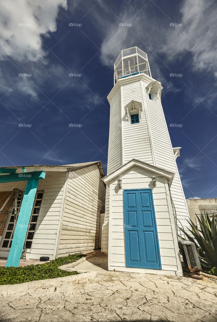 White and blue lighthouse: the lighthouse of Isla Mujeres in Mexico.