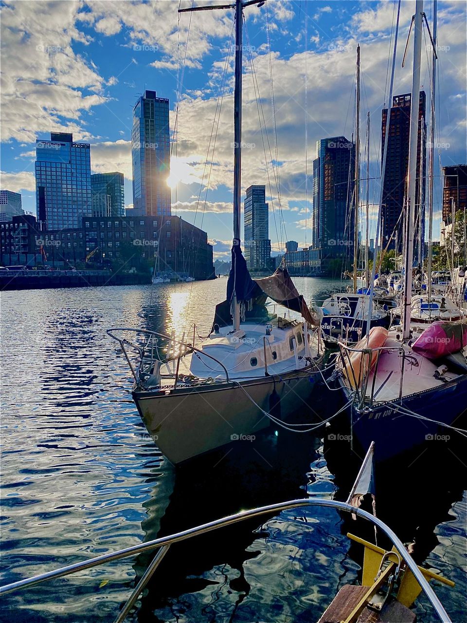 This is beautiful “Newtown Creek” by the “Pulaski Bridge” in LIC, Queens with its picturesque boats that are tied to the shore here. The setting sun with its glorious golden glow is reflected back by the ocean. 2023. Hypnotic Productions