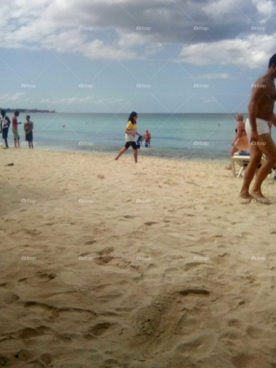 a day at the beach Ware we meet new people an have a lot of fun 
 an which people  walking by