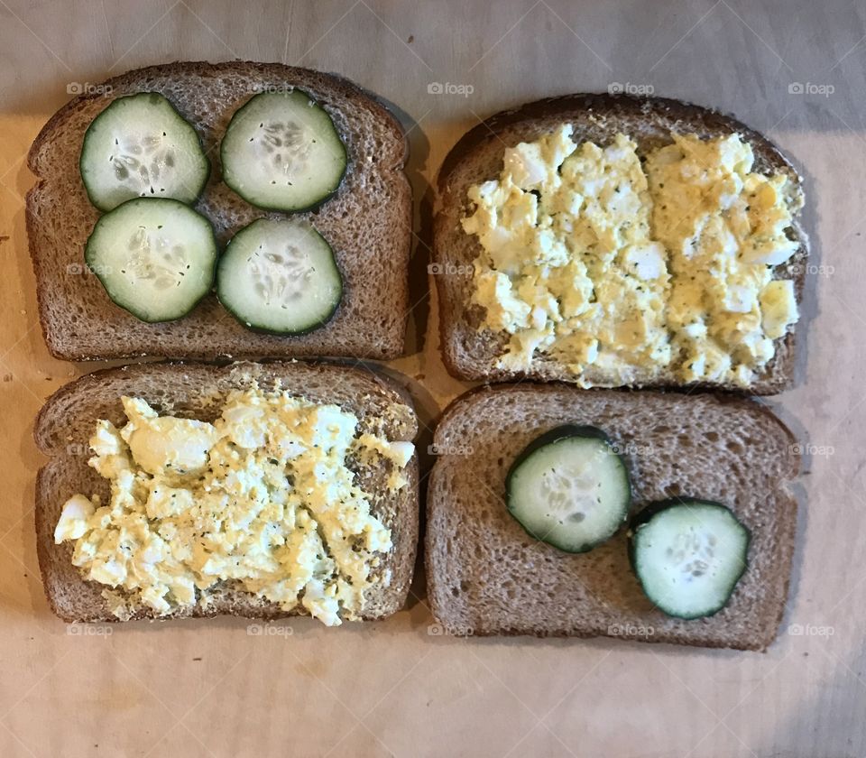 Egg salad sandwiches on a cutting board