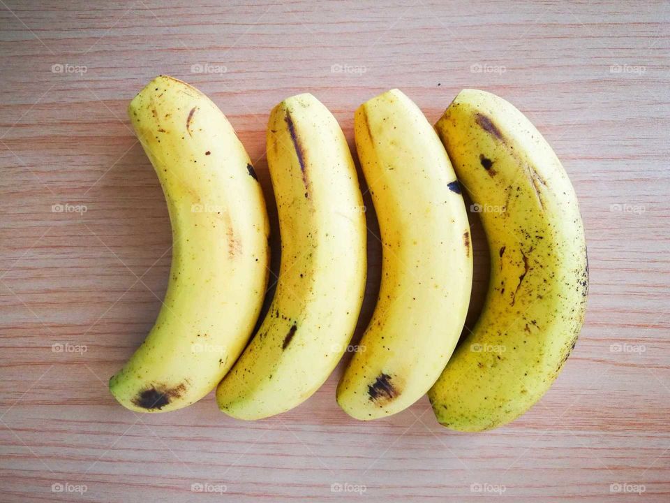 Ripen bananas on wooden table