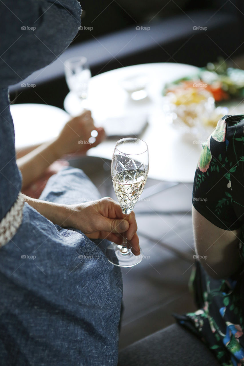 Woman sitting with champagne glass at a party