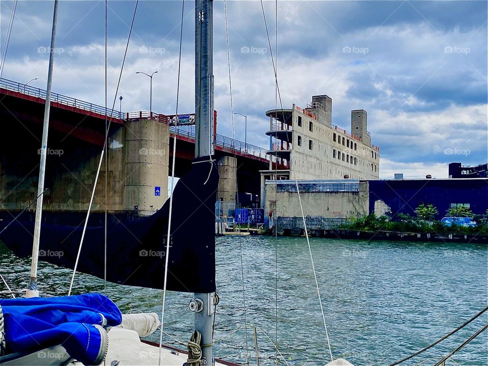 This is the „Pulaski Bridge“ at „Newtown Creek“ in LIC, Queens seen from aboard „Salvation“, the „28 ft 1969 Luhrs“ cabin cruiser that I, „Petra Schiller“ and my longtime partner „Timothy Trespas“ call home. 2023. Hypnotic Productions