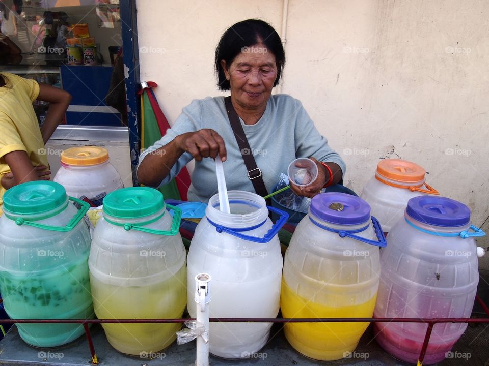 street food vendor. street food vendor sellings fruit juices in antipolo city, philippines in asia