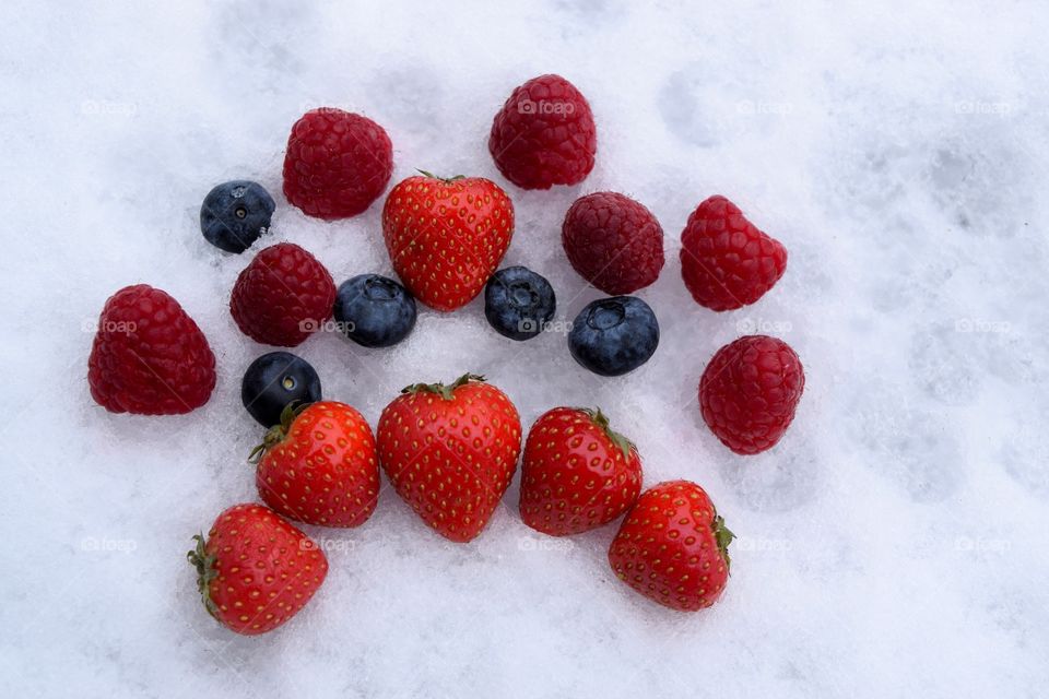 Fruits on snow during winter