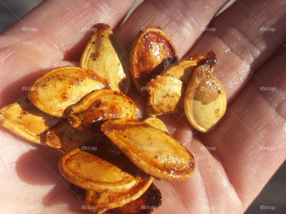 Close-up of pumpkin seeds in hand