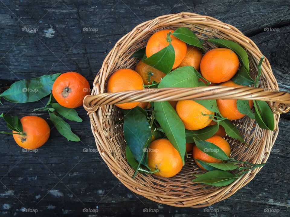 Elevated view of tangerines in basket