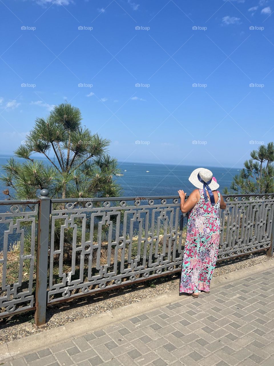 woman standing on the beach in a long dress