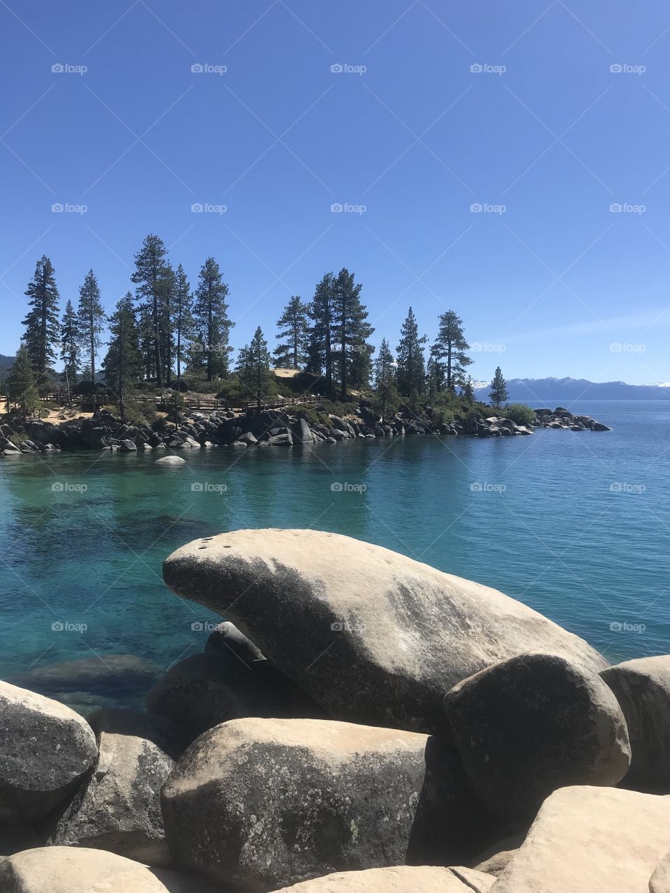 Sand Harbor in Lake Tahoe. The view of large rocks and pine trees on the lake. 