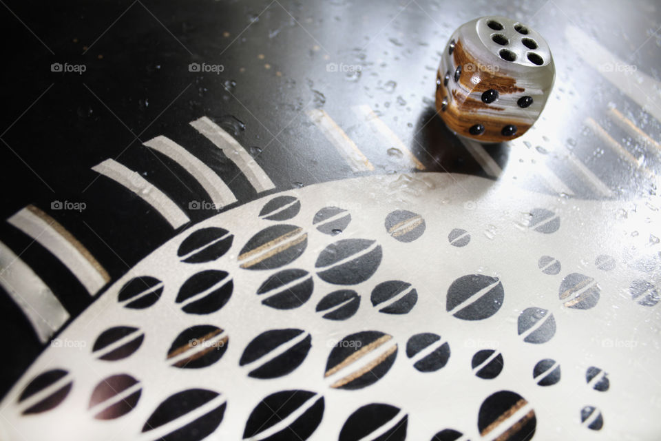 A lucky dice on an artistic table