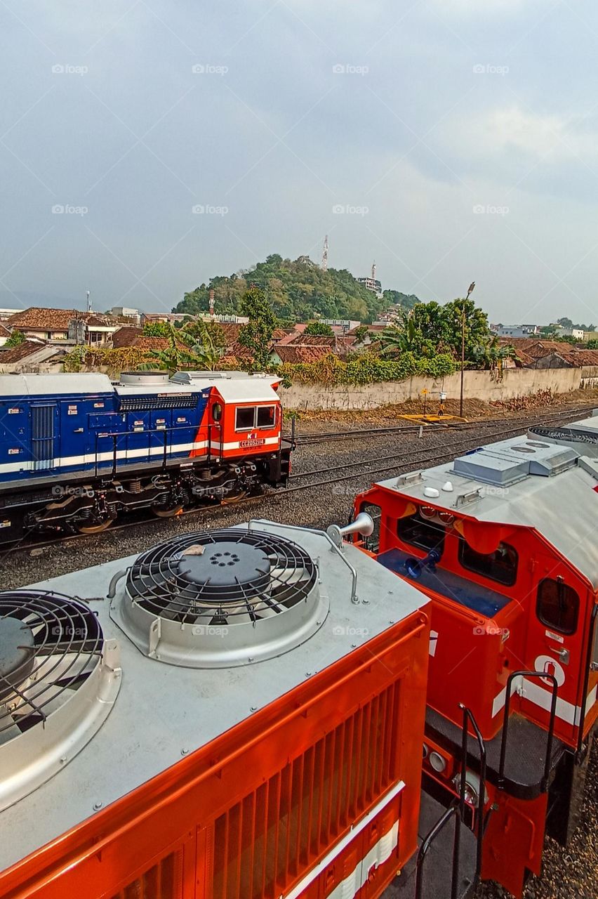 A locomotive towing a long series of coal at the Tanjung Karang Locomotive Depot, Lampung, Indonesia