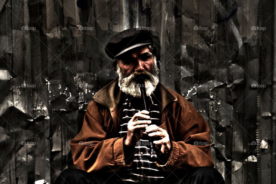 Oldman. I was walking istiklal street this oldman was playing flute. He is street musician