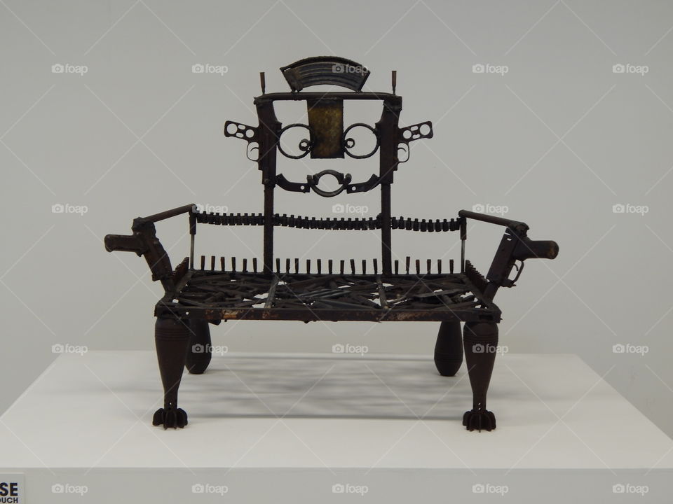 seat made out of recycled guns and ammunition