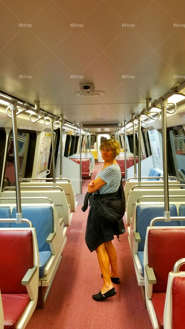 Mature woman standing in train