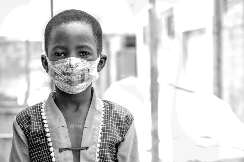 Local boy wearing locally made nose mask made from empty sachet water nylon to protect himself against covid-19 in kano Nigeria 
