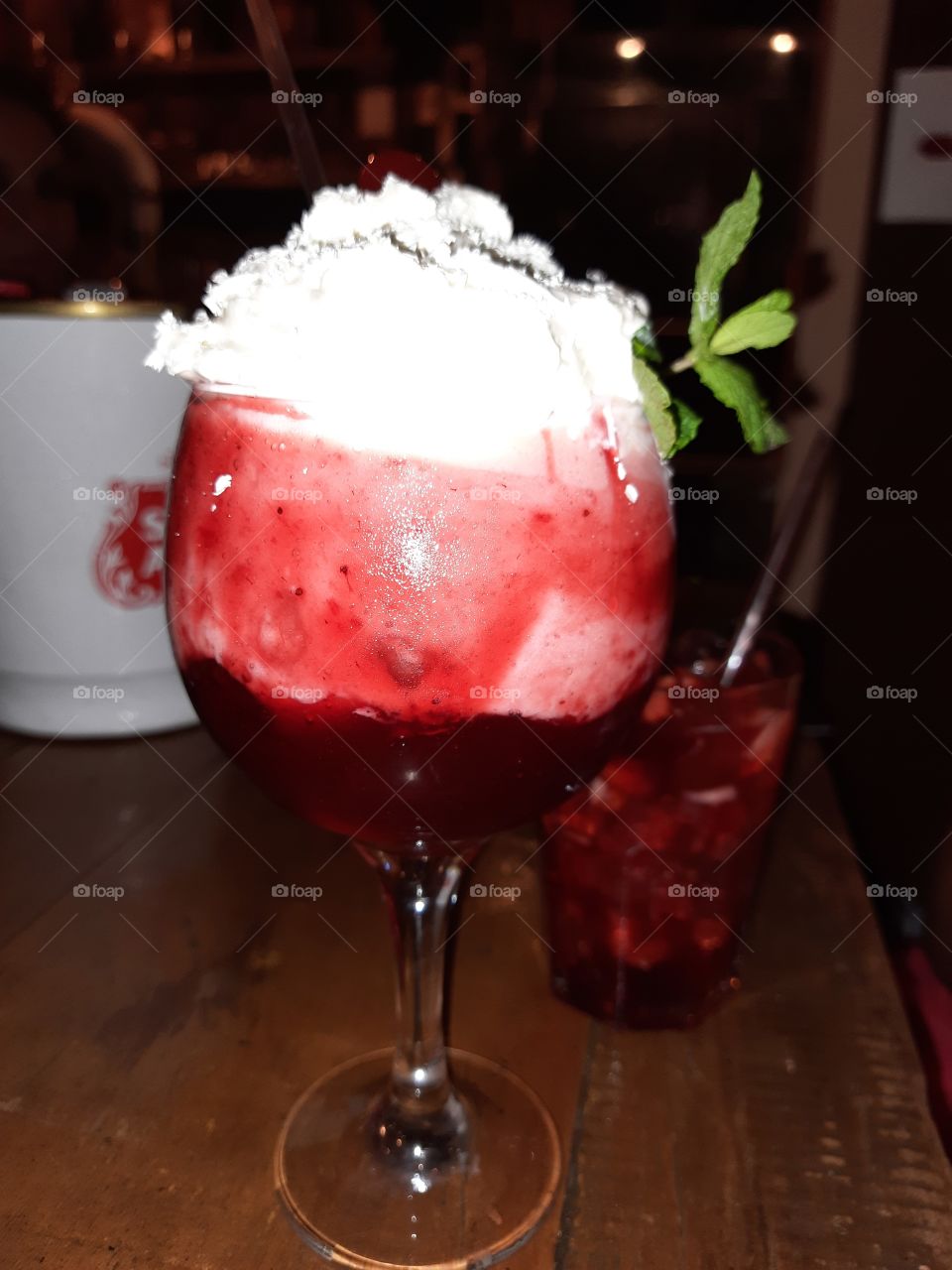 Strawberry drink with whipped cream and strawberry caipirinha