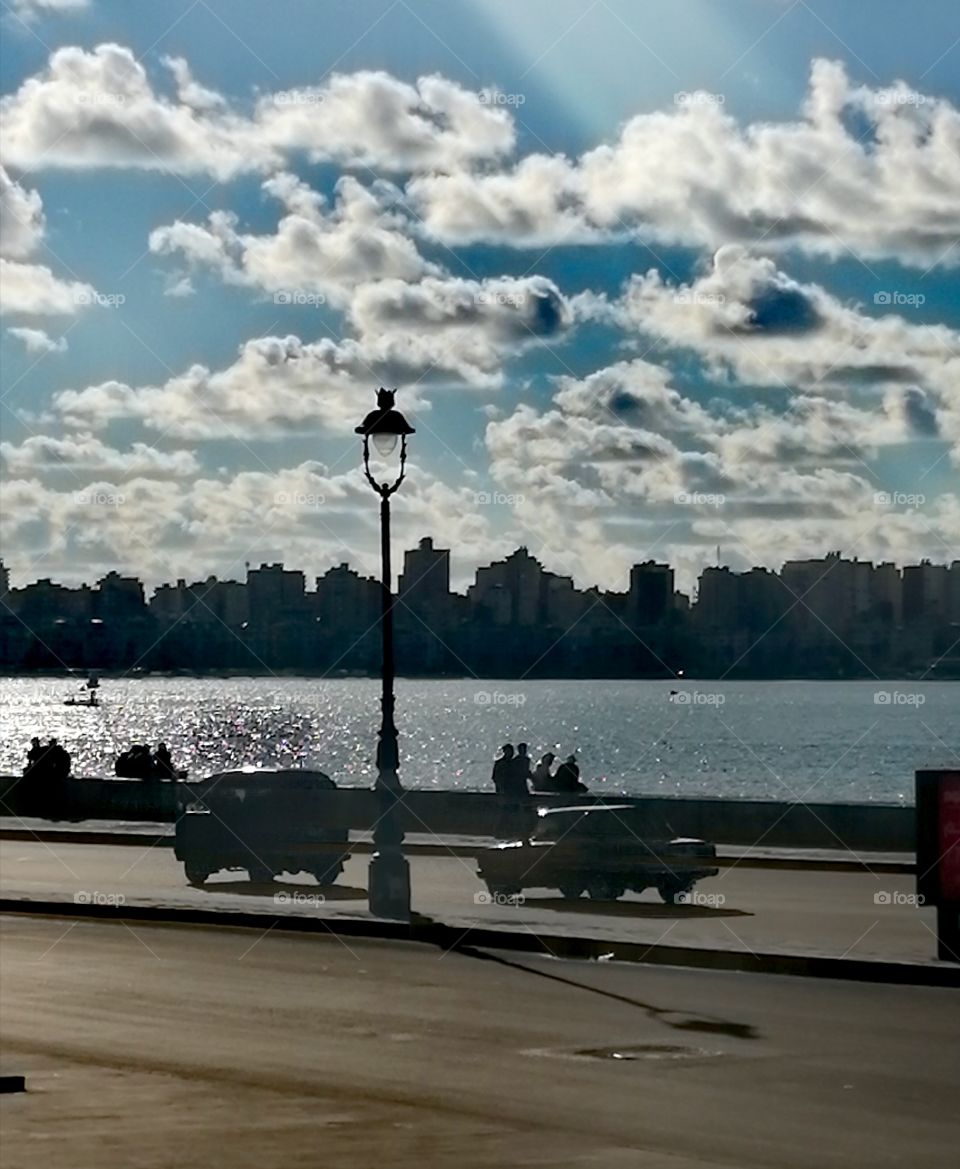 The beautiful sea of Alexandria with the view of buildings, clouds and streets