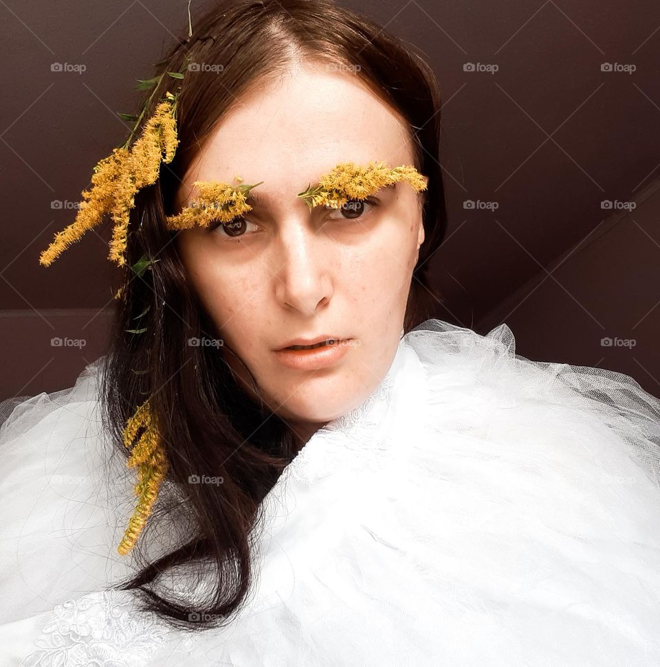 Portrait of an angry girl with flowers