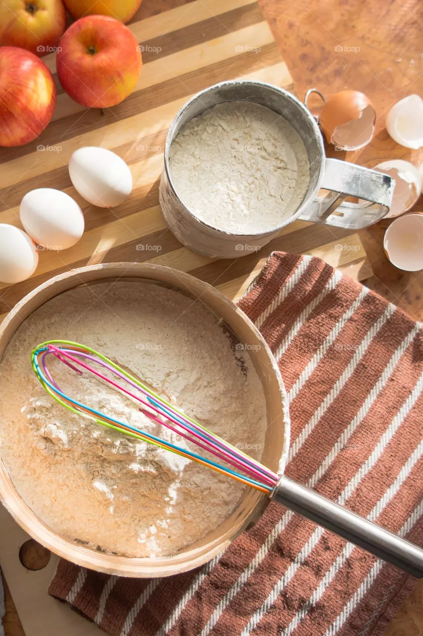 Making homemade puffed apple pie with eggs, sugar and flour.