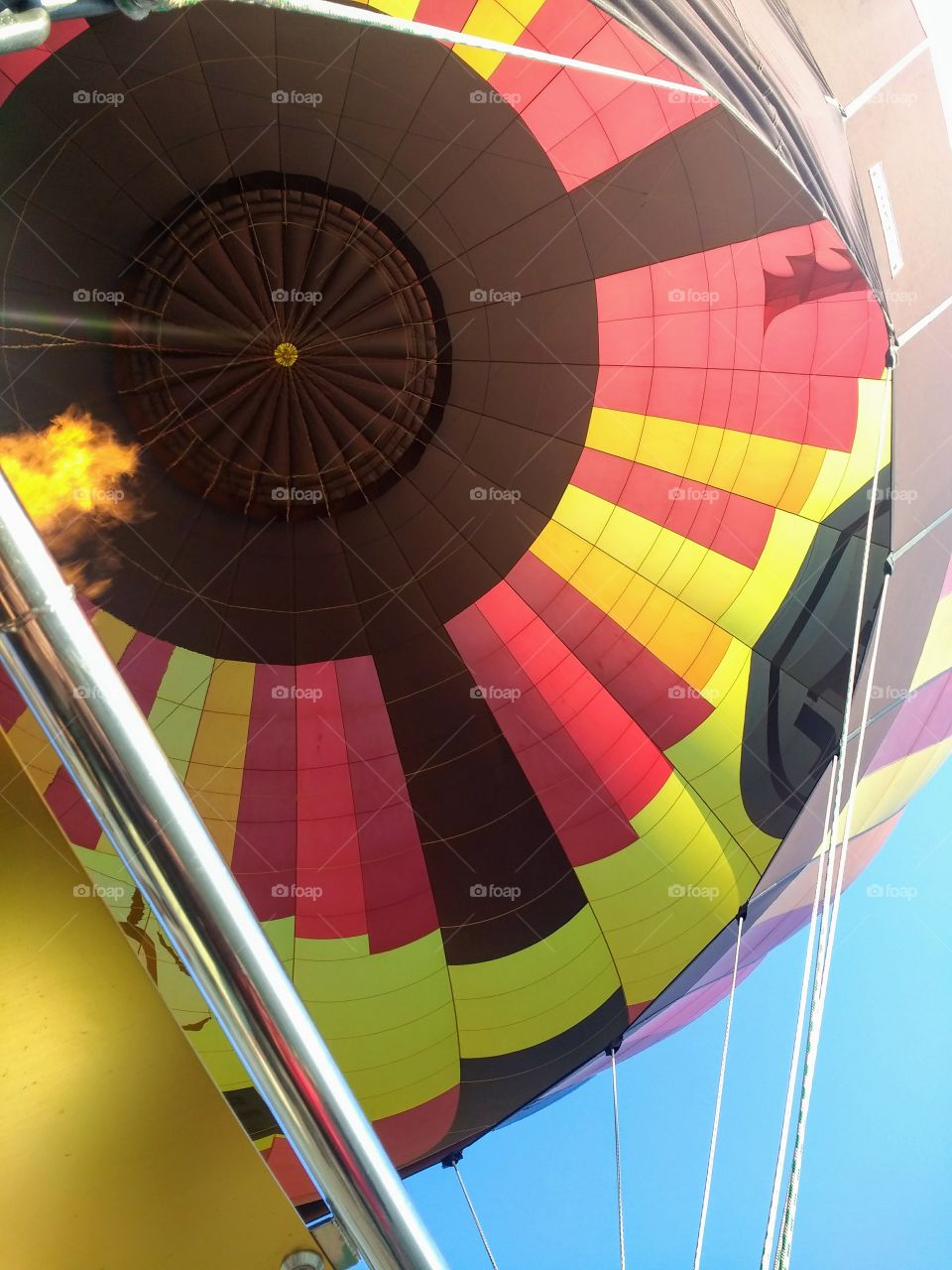 Flying in a red, yellow, and brown hot air balloon