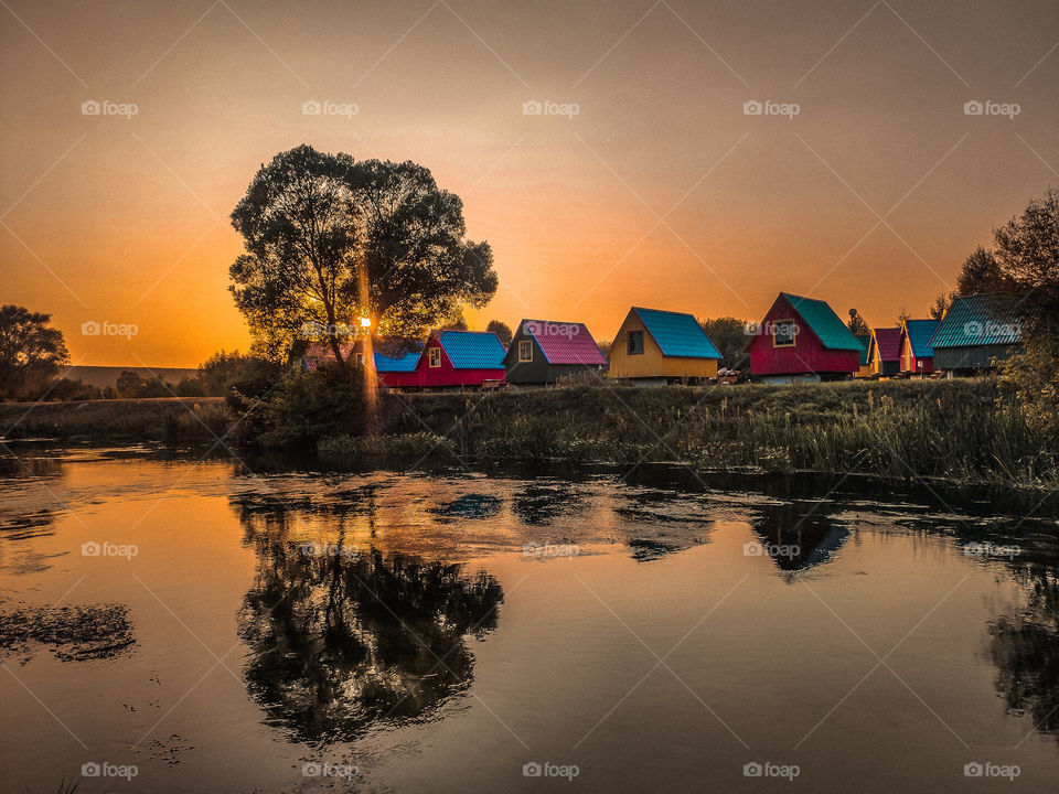 colorful houses on the river at sunset