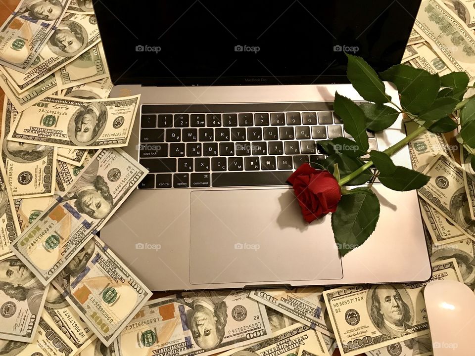 Red rose on the laptop keyboard. Online business, success, profit, online professional