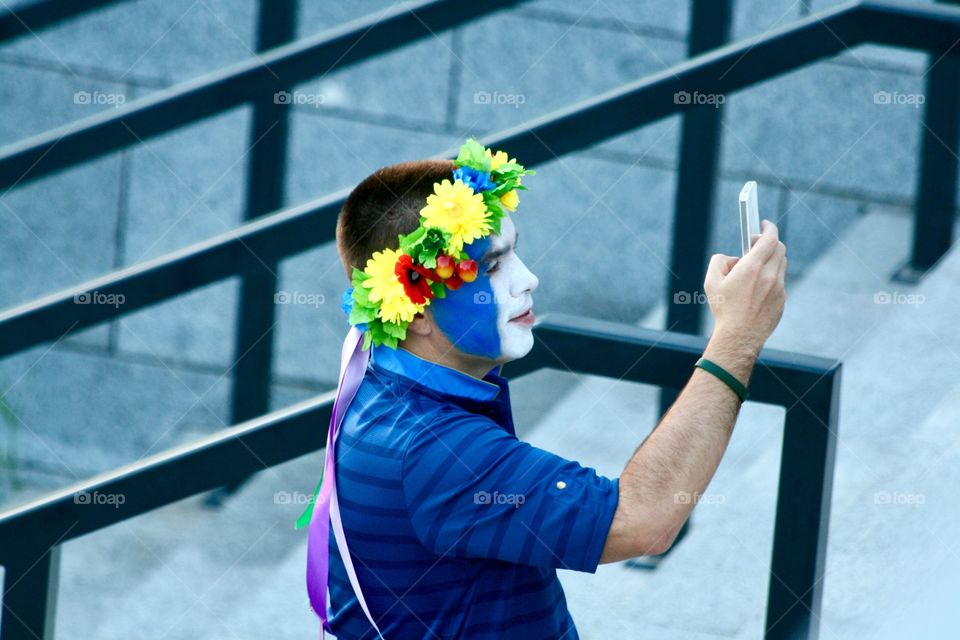 A football fan taking a picture