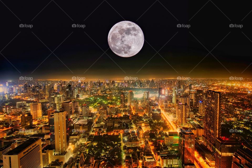 Full moon over central city Bangkok Thailand