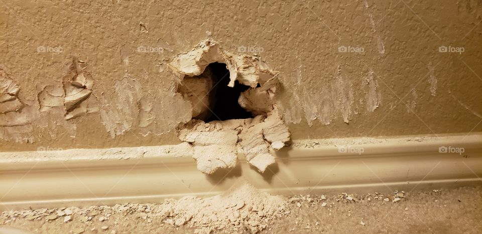 Damaged drywall - hole in house's bedroom wall