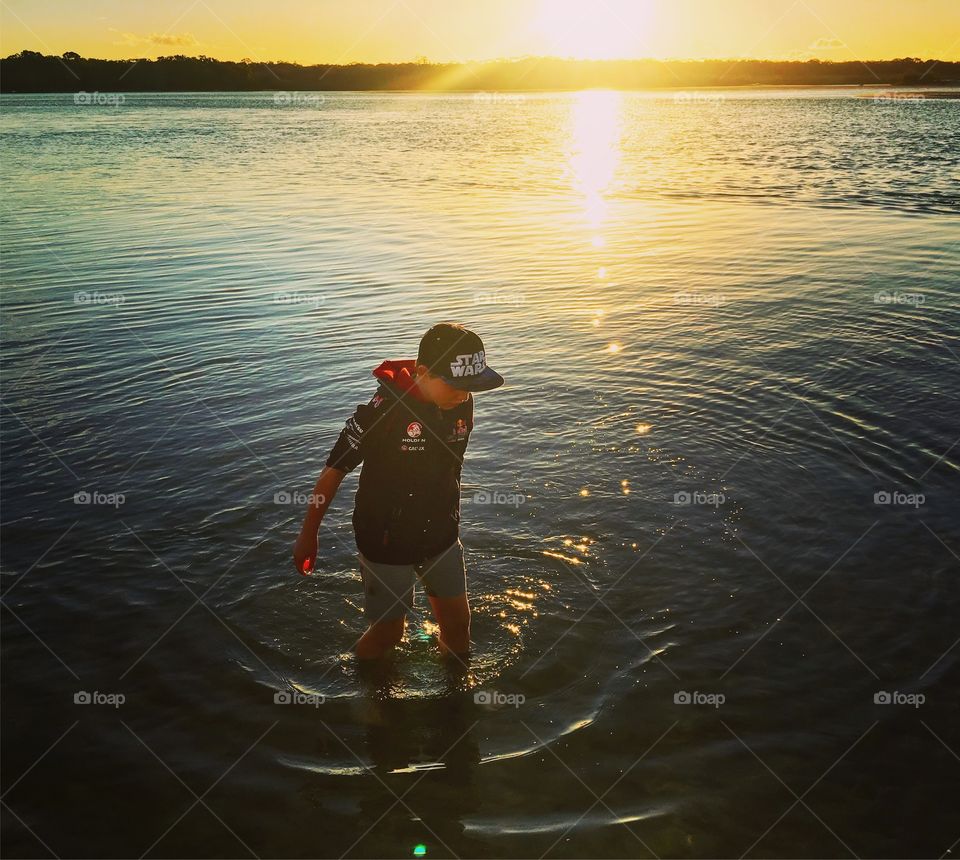Playing in the sea at sunset 
